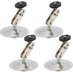 four glass holders with black knobs on each side and one is holding an object