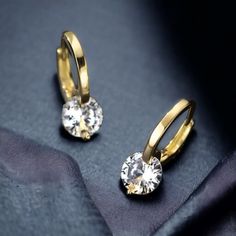 Discover the epitome of elegance with our stunning Diamond Drop Hoop Earrings, expertly crafted from 14k Gold Plated 925 Sterling Silver. Each earring features a brilliant round-cut Moissanite stone, sized at 6.5mm (1.0ct each), ensuring a dazzling sparkle that captures the eye. Available in both White Gold and Yellow Gold, these vintage-inspired classic earrings are the perfect accessory for any special occasion. Key Features: Stone Cut: Round Stone Size: 6.5mm (1.0ct each) Color Options: White Cubic Zirconia Round Hoop Earrings, Gold Hoop Drop Earrings With Prong Setting, Small Hoop Cubic Zirconia Crystal Earrings For Gift, Small Hoop Crystal Earrings With Cubic Zirconia As Gift, Cubic Zirconia Small Hoop Earrings, Small Hoop Cubic Zirconia Earrings With Ear Wire, Dazzling Cubic Zirconia Huggie Earrings As Gift, Diamond Cut Dangle Hoop Earrings For Gift, Diamond Cut Dangle Huggie Earrings As Gift