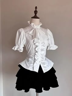 Step into the world of gothic elegance with our White Jabot Collar Gothic Prince Style Ouji Short Sleeves Shirt. This exquisite piece features a refined jabot collar, exuding an air of aristocratic charm. The lace-up detail at the back not only adds a touch of classic sophistication but also ensures a perfect fit, accentuating your slim waist. This shirt combines the timeless allure of gothic fashion with the regal essence of prince-style attire.   	 		 			Size 			S 			M 			L 			XL 		 		 			Full Shirt Collar Reference, Music Conductor Outfit, Jester Outfit Male, Japanese Outfit Ideas, White Outfit Elegant, Ouji Aesthetic, Prince Outfits Aesthetic, Ouji Outfit, Ouji Fashion Female