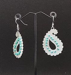 Stunning, statement, sterling silver paisley tear drop shaped earrings highlighted with tiny, turquoise coloured  glass beads.  The complex shapes of the earrings are skilfully hand sawn (pierced) from a sheet of recycled silver and then the beads are hand sewn into drilled holes.  The unique marriage of silver and beading is firmly secured and preserved with museum grade varnish.  The elegant earrings have an Eastern or Asian influence. Paisley or paisley pattern is an ornamental textile design Complex Shapes, Paisley Wallpaper, Coloured Glass, Clothing And Textile, Floral Spray, Pink Paisley, Recycled Silver, Paisley Design, Turquoise Color