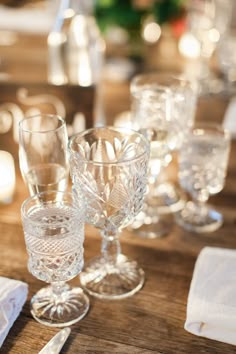 there are many glasses on the table ready to be used as place settings for an event