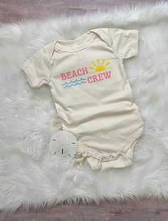 Time to head to the beach! Grab your beach crew and head out! This bodysuit is great for a beach vacation or everyday wear.  Taking a family trip? Grab one for the whole group. Comfy enough for your little one to play in all day!  All shirts are made to order and my current turn around time is about 2 weeks until your order will ship. Please keep this in mind when ordering. Playful Swimwear For Summer Adventures, Spring Beach Onesie With Short Sleeves, Cute Swimwear With Upf 50+ For Beach, Cute Upf 50+ Swimwear For Beach, Fun Summer Onesie With Short Sleeves, Fun Short Sleeve Onesie For Summer, Playful Onesie For Spring Beach Outings, Playful Onesie For Beach In Spring, Playful Cotton Swimwear With Upf 50+