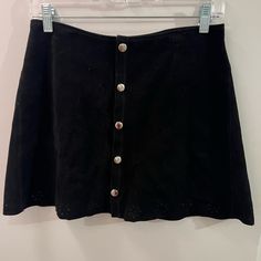 Suede Black Button Skirt With Floral Cutouts. Never Worn Fall Night Out Skirt With Buttons, Chic Mini Skirt With Snap Buttons, Chic Skirt With Buttons For Night Out, Black Button Closure Mini Skirt For Summer, Mini Skirt With Buttons For Day Out, Fall Night Out Skirt With Button Closure, Black High Waist Mini Skirt With Buttons, High Waist Black Mini Skirt With Buttons, Black Buttoned Mini Skirt