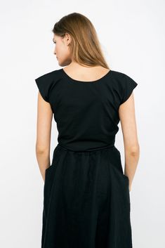 An artfully engineered top built for versatility and adaptability. This blouse can be worn with the knot in the front or the back, and also works wonderfully layered over tanks and dresses. Try tying it loosely for a relaxed fit, or tightly for a waist-cinching, pin-up silhouette. It boasts a low v-neck front- or full coverage in front with a low v-open back. Try tying the knot around the center front or back of your bra to help disguise it and keep the top securely in place. Simple rolled hems Summer Tops With Ruched Back, Casual Fitted Top With Ruched Back, Fitted Casual Top With Ruched Back, Sleeveless Summer Tops With Ruched Back, Chic Summer Tops With Ruched Back, Casual Ruched Back Top For Spring, Versatile Sleeveless Top With Tie Back, Versatile Stretch Top With Ruched Back, Chic Sleeveless Top With Tie Waist