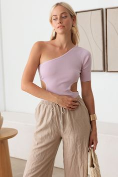 Introducing the edgy and stylish One-Shoulder Cutout Bodysuit, available in Lavender, Cedar, and Sky Blue! This bodysuit is perfect for making a bold fashion statement while ensuring you look effortlessly chic. This bodysuit features a unique one-shoulder design that adds a modern and asymmetrical touch to your outfit. The cutout detail on the side creates an eye-catching and trendy look, making this bodysuit ideal for those who love to stand out. Crafted from a soft and stretchy ribbed knit fab One Shoulder Fitted Bodysuit For Spring, Fitted One-shoulder Bodysuit For Spring, One Shoulder Bodysuit For Night Out In Spring, Spring One Shoulder Bodysuit For Night Out, Trendy Off-shoulder Solid Color Bodysuit, Trendy Solid Color Off-shoulder Bodysuit, Spring Off-shoulder Solid Bodysuit, One Shoulder Fitted Cutout Bodysuit, Chic Fitted Purple Bodysuit