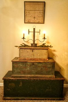 an old wooden box with candles on top