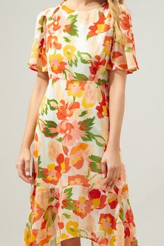 Take on the day in this spritely floral midi dress. A spirited floral print with silver pinstriping is woven into a sheer and flowy fabric. It shapes the Aerin Midi, a flowy dress with sheer, flouncy sleeves frame a lined bodice and asymmetrical skirt. An imbalanced hemline creates an ethereal touch. An elastic waistband is placed along the back side, as well as a keyhole.- Keyhole- Lined- Asymmetrical hem- Elastic waist- Color: Blush MultiSize + Fit - Model is 5'9" and wearing size XS- Measurem Flowy A-line Floral Dress, Summer Floral Midi Dress Lined, Summer Floral Lined Midi Dress, Summer Floral Midi-length Lined Dress, Spring Printed Knee-length Midi Dress, Breezy A-line Spring Dress, Spring Knee-length Printed Midi Dress, Lined Floral Midi Dress For Summer, Lined Summer Midi Dress