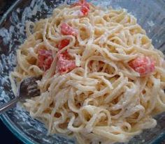 a glass bowl filled with pasta and meat