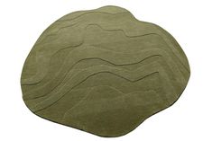 a green rug with wavy lines on the top and bottom in different sizes, shapes and colors