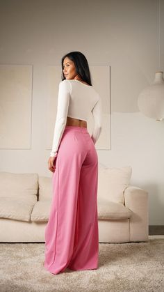 Make a statement in these pink asymmetrical high-waisted trouser pants. These modern-style dress pants feature an asymmetrical cut for a unique look. Crafted from high quality material, these pants are designed to offer both comfort and style. Elevate any outfit with these distinctive trousers. Fabric & fit: 96% POLYESTER 4% SPANDEX Model is wearing size Small. Chic Fitted Asymmetrical Pants, Trendy Asymmetrical Solid Bottoms, Trendy Solid Asymmetrical Bottoms, Asymmetrical Solid Bottoms For Work, Asymmetrical Solid Bottoms For Workwear, Spring High Waist Bottoms With Side Slits, Spring High-waist Bottoms With Side Slits, High Waist Bottoms With Side Slits For Spring, Pink Stretch Wide Leg Pants