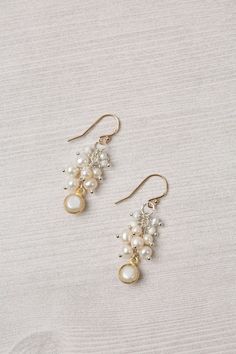 Experience the beauty and craftsmanship of the Seaside Collection with these gorgeous handmade earrings.    Mixed Metal (lead and nickel free) Pearl 1.5", with gold filled ear wires We hand select our natural materials, thus there may be slight variations in color and/or size that will not detract from the overall aesthetic Our unique handcrafted designer jewelry for women is made in America, with each design created individually in our personal design studio in Floyd VA USA Gold Dangle Cluster Earrings With Pearl Drop, Handmade Dangle Cluster Earrings For Anniversary, Elegant Brass Wire Wrapped Earrings, Handmade Dangle Pearl Earrings In 14k Gold Filled, Handmade 14k Gold-filled Dangle Pearl Earrings, Handmade 14k Gold Filled Dangle Pearl Earrings, Gold Beaded Sterling Silver Earrings For Gift, Wire Wrapped 14k Gold Filled Earrings For Wedding, Gold Sterling Silver Beaded Earrings For Gift