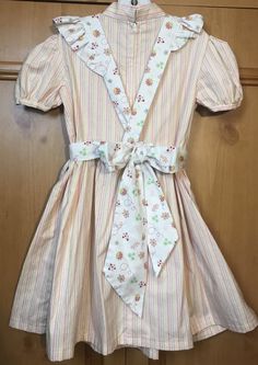 "Dress length (shoulder to bottom hem)27\"/pit to pit 13\"/waist 12 1/2\"/ Apron length (shoulder to bottom hem) 22\"/waist adjustable with sash tie/No pattern supplied/dress is pink green and white striped the apron has a lady bug pattern. The dress is sewn from a 1969 vintage pattern/Please pay attention to measurements size vintage six but please pay attention to measurements/smoke free environment(39)" Cute Cotton A-line Sundress, Cute A-line Cotton Sundress, Cute A-line Dress For Casual Wear, Cute Fitted A-line Dress, Cute A-line Sundress For Garden Party, Cute A-line Dress For Dress-up Occasions, Cute Summer Vintage Dress With Doll Collar, Fitted Cotton Dress For Garden Party, Cotton Sundress With Fitted Bodice