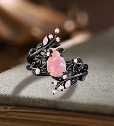 Unique Pear Pink Fire Opal Engagement ring Set Gothic Art deco Black Gold Cluster Vine Leaf Wedding Band Vintage Stacking Bridal Promise Set Applicable scene: anniversary, birthday party, wedding, engagement, gift ■ Handmade, high-quality item! ■ Material: S925 Sliver SOLID 14K/18K BLACK GOLD (can be made in white/rose/yellow gold) Engagement ring ■ Center stone: Pink Opal ■ Size/Weight: 6*8mm pear ■ Side stones: Pink Opal ■ Total weight: 0.042 ct (High Quality) ■ Cut - VG ■ Color: G-H ■ Clarity Black Diamond Wedding Rings Flower, Opal Engagement Ring Black Band, Luxury Gemstone Promise Wedding And Engagement, Opal Wedding Ring Black Band, Unique Engagement Rings Black Opal And Silver, Unique Purple Engagement Rings, Black And Pink Wedding Rings, Engagement Rings Gothic, Unique Opal Engagement Rings