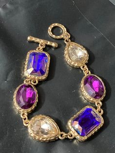 vintage 1970s Gold tone chain link charm bracelet with chunky diamanté purple clear Oval cabochons 20cm Purple Gemstone Metal Jewelry, Vintage Purple Metal Bracelets, Purple Oval Jewelry For Party, Purple Oval Party Jewelry, Metal Crystal Bracelet Costume Jewelry, Jeweled Metal Crystal Bracelet Costume Jewelry, Lovely Earrings, Drop Pendant, Vintage 1970s