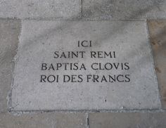 the inscription on the sidewalk reads, i saint remi bapitsa clovis roi des frances