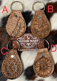 four leather key chains with different designs on them