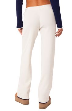 A low rise adds to the retro flair of these chic and comfortable ribbed pants. 50% polyester, 50% rayon Machine wash, dry flat Imported Ribbed Elastane Bottoms For Loungewear, Chic Ribbed Elastane Bottoms, Trendy Ribbed Elastane Bottoms, Solid Bottoms With Ribbed Cuffs For Workwear, Fitted Pants With Ribbed Cuffs, Spring Ribbed Elastane Bottoms, Elegant Ribbed Bottoms, Elegant Ribbed Spring Pants, Trendy Ribbed Workwear Bottoms