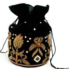 "Look your best wearing this luxurious black velvet pouch bag, exquisitely embroidered with glittery metallic red threads and genuine semi precious stones. It is certain to bring you compliments. Perfect color for Indian wedding! Expertly hand embroidered by third generation master zardozi artisans. Of heirloom quality. - Measures approx 9\" tall, base is 6\" across. - Useable interior space is 6\" x 6 \". - Rigid bottom and 2\" base, so bag sits nicely. - Wrist cord with tassel, 6 in. drop - Ad Festive Embellished Potli Bag As Gift, Luxury Embroidered Festive Bags, Embellished Pouch Potli Bag For Festivals, Embellished Potli Pouch Bag For Festivals, Bohemian Embellished Potli Bag As Gift, Traditional Embellished Pouch As Gift, Gold Embroidered Potli Bag For Festivals And Parties, Gold Embroidered Potli Bag For Party And Festivals, Bollywood Style Embellished Potli Bag For Festivals