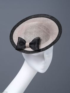 Fantastic and unique cocktail hat, made for an exceptional woman. There is a beige rim on the black base. Black trim and a simple bow are a very elegant finish. We put on the head with an elastic band. We wear it on the right side slightly in the front. It looks great with simple and classically cut clothes. * Handmade item * Fabric: beige black sinamay * Additional materials: black bow, black trim, hat diameter 10 inches * rubber * One size fits all * Worldwide shipping from Poland If you want Chic Hats With Bow And Curved Brim, Elegant Adjustable Hat With Bow, Brimmed Boater Hat With Bow For Kentucky Derby, Classic Black Boater Hat For Party, Kentucky Derby Party Hat With Satin Bow, Chic Brimmed Boater Hat With Bow, Boater Hat With Bow For Kentucky Derby, Chic Adjustable Boater Hat With Bow, Elegant Adjustable Mini Hat With Bow