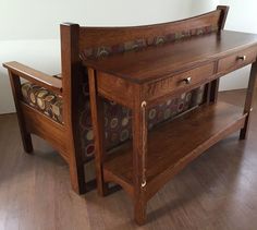 a wooden table with two benches next to each other on a hard wood flooring area