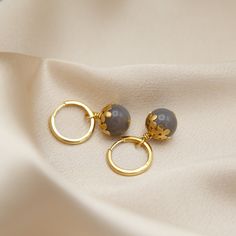 New stone options for our perfectly paired daisy cap and gemstone hoop earrings. Now on gold over sterling silver hoops; a higher quality hoop with greater longevity. Wear solo or pair with the Simone Necklace. Materials & Details Brass daisy caps 12mm grade A stones with natural variation Stone options: Aquamarine, Blue Kyanite, Blue Tigers Eye, Carnelian, Dalmation Jade, Faceted White Moonstone, Garnet, Golden Tigers Eye, Gray Agate, Green Aventurine, Green Onyx, Malachite, Opalite, Pyrite, Re Gold Agate Gemstone Earrings, Gold Agate Earrings For Jewelry Making, Gold Agate Drop Earrings, Golden Tigers, Golden Tiger, Gemstone Hoop Earrings, Grey Agate, Blue Tigers, Red Tigers Eye