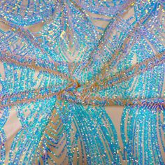 blue and gold sequins are on the back of a piece of fabric that has been draped over