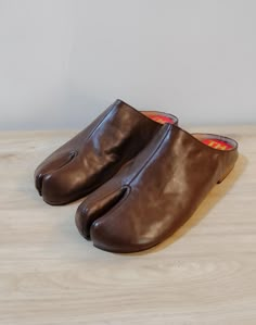 Beautiful handmade leather Japanese Tabi mules  with split toe design,completely hand stitched from top to bottom. The boots are made with soft supple leather and are very comfortable and will mold to your foot with time. Pre order: Please note these mules are made upon order and will take 4-6 weeks to complete and ship. Handmade with top quality materials and stacked leather soles. The shoes will have minor imperfections do to handmade handling and painting. Sizes: 7-11 or 37-41 Please contact Leather Mules With Plain Toe And Leather Sole, Brown Open Toe Mules With Stitched Sole, Leather Mules With Plain Toe And Stitched Sole, Leather Mules With Stitched Plain Toe, Leather Mules With Stitched Sole And Plain Toe, Brown Leather Slippers With Almond Toe, Leather Square Toe Mules With Rubber Sole, Brown Mules With Leather Footbed And Single Toe Strap, Brown Mules With Single Toe Strap And Rubber Sole