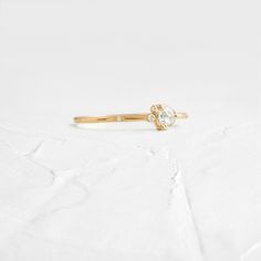 4mm rose cut white diamond (SI clarity) SI clarity white diamonds (1mm -1.5mm) Solid 14k gold setting with a delicate 1.2mm round band (available in yellow, rose, or white gold) Total carat weight: .18ct. We handcraft each piece with responsibly sourced 14k gold and ethically sourced stones. Minimalist Yellow Gold Wedding Ring With Rose Cut Diamonds, Delicate Diamond Ring With Round Band, Dainty Diamond Ring With Single Cut Diamonds, Dainty White Round Cut Diamond Ring, 14k Gold Diamond Ring With Rose Cut, Everyday Diamond White Diamond Ring With Brilliant Cut, Minimalist Moissanite Diamond Ring In Yellow Gold, Dainty Round Lab-grown Diamond Ring, Dainty Lab-grown Diamond Round Ring