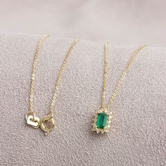 "Emerald, which is considered to be the stone of love, sensitivity and loyalty, is seen as a symbol of harmony in relationships. The green color of the emerald symbolizes luck, youth and rebirth. Our Rectangle Emerald necklace surrounded by 14K Solid Gold diamonds is an elegant jewel for you and your loved ones with its elegant design. Time to pamper yourself and your loved ones... Emerald is the birthstone of May. You can find our matching ring with our necklace here https://queenjewelryturkey. Elegant 14k Gold Emerald Necklace With Delicate Chain, Elegant Gold Plated Emerald Necklace For Gift, Elegant Yellow Gold Necklaces With Rectangular Stone, Elegant May Birthstone Necklace With Rectangular Pendant, Elegant Emerald Necklace With Rectangular Pendant May Birthstone, Elegant Emerald Necklace With Rectangular Pendant For Gift, Elegant Emerald Necklace With Rectangular Pendant For May Birthstone, Elegant Rectangular Emerald Pendant Necklace As Gift, Elegant Emerald Necklace With Rectangular Pendant