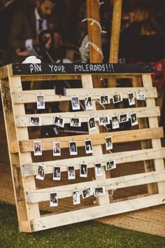 a wooden pallet with pictures pinned to it and the words pin your polaroids