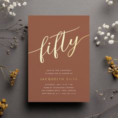 a brown and gold wedding card with the word fifty written in cursive font