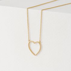 Anabella Follow your heart and it’ll lead you to our 14k gold necklaces. Add a touch of timeless elegance with our delicate Heart Cut-Out Pendant in Solid Gold. This beautiful pendant features a classic heart shape with a modern open center design. Crafted from 14k solid gold (available in yellow, white, or rose gold), this pendant offers long-lasting quality and a luxurious shine. Its versatility makes it perfect for any outfit, and it's a thoughtful gift symbolizing love and affection. - Handm Heart Cut Out, 14k Gold Necklace, Follow Your Heart, Gold Necklaces, White Gift Boxes, Gold Set, Perfect Gift For Her, Diamond Cut, Cable Chain