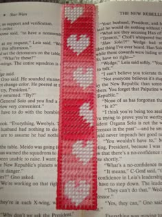 an open book with red and white hearts on it