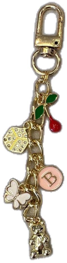 a gold key chain with charms attached to it's sides and the letter b on top