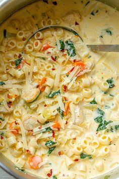 a large pot filled with pasta and vegetables