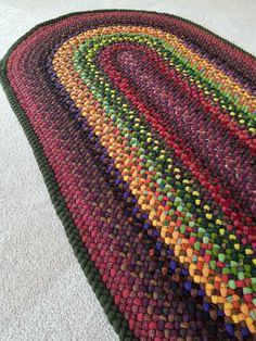 a multicolored rug is laying on the floor