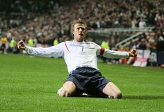 a man sitting on top of a soccer field