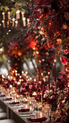 a long table with candles and flowers on it