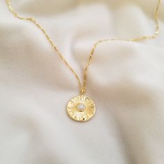 "An opalescent center stone adds to the striking found-object aesthetic of a sunburst-etched coin pendant necklace. ♥ Measurement of pendant: 18 mm tall and width (gold plated) ♥ Available in 16\", 18\", 20\", 22\" and 24\" figaro chain length (gold plated on the top of 925 sterling silver) ♥ Width of figaro chain: 1.5 mm ♥ Spring ring clasp ♥ Nickel free ♥ All items are packed inside an elegant Gold Spoon jewelry box. If you are purchasing a product to send as a gift, we can send the product di Necklace Gold Pendant, Gold Medallion Necklace, Necklace Sun, Simple Jewellery, Figaro Necklace, Necklace Opal, Figaro Chain Necklace, Gold Coin Necklace, Sun Pendant