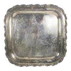 an old silver plate with a man's face in the center, on a white background