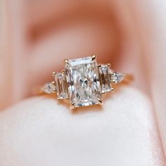 an engagement ring with three diamonds on it