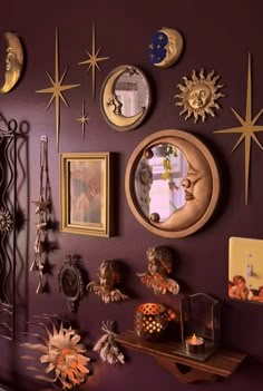 a purple wall with many different items on it and some pictures hanging up against the wall