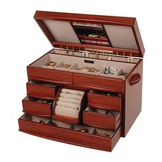 an open wooden jewelry box with many drawers