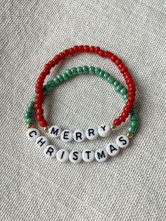 Mommy and Littles co Merry Christmas bracelet set. Super cute to wear together or add to a stack 🎄 Perfect to get as a gift or to get for yourself this holiday season! Details: *4mm seed beads. *acrylic black and white letter beads. *Made with jewelry quality elastic. *14k gold plated beads. *please message if you are needing a size that is not listed! *NOTE: this listing is for TWO bracelets. Adjustable Bracelets For Holiday Gifts, Handmade Holiday Bracelets, Red Beaded Bracelet With Letter Beads For Holidays, Green Beaded Bracelets For Holiday Gifts, Adjustable Beaded Bracelets For Holiday, Holiday Gift White Beaded Bracelets, Handmade Adjustable Christmas Bracelets, Adjustable Bracelet For Christmas Gift, Adjustable Beaded Bracelet Christmas Gift