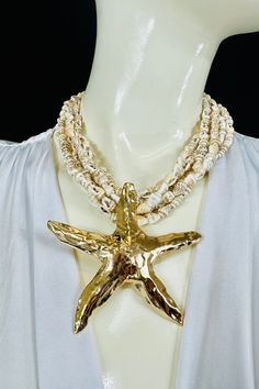 It is designed to evoke a sense of the ocean and beach vibes, with its multiple strands of small shells and a prominent starfish pendant as the focal point. The necklace is a bold and eye-catching accessory that can add a touch of seaside charm to any outfit. This unique piece features a vibrant, White beaded strand that measures 18 inches in total length, ensuring a perfect fit around your neckline. The highlight of this necklace is the striking starfish pendant, which measures 3 inches, adding Trendy Gold Necklace, Ocean And Beach, Belt Ring, Casual Beach Wear, Pretty Necklace, Starfish Pendant, Pretty Necklaces, Necklace White, Beach Vibes