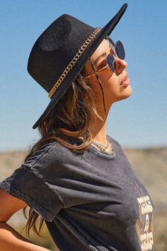 A timeless accessory to top off any look! Our Women’s Chain Wide Brim Hat is made with a soft felted wool material and a wide, structured brim. This hat has a high crown and teardrop top. Accentuated with a gold chain trim for a super chic look! This hat has an adjustable interior to fit you perfectly. Pair this hat with our jeans, a shacket, and booties for an effortless look!Product Details- Wool Fabrication- Adjustable Inner Tie- Tribal BandSize & Fit- O/S- Width: 14.5”- Length: 16”- Brim: 3. Trendy Cheap Gold Hats, Trendy Short Brim Felt Hat For Festivals, Chic Curved Brim Festival Hat, Chic Curved Brim Hat For Festivals, Chic Brimmed Hat As Fashion Accessory, Trendy Curved Brim Felt Hat For Festivals, Chic Short Brim Festival Hats, Chic Short Brim Hats For Festivals, Chic Festival Hats With Short Brim