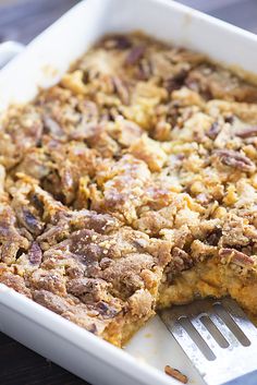 a close up of a casserole on a plate with a fork in it