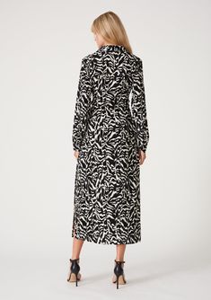 A classic maxi shirtdress designed in a black and off-white abstract print. Abstract boho print Relaxed fit Long sleeves Button wrist closure Maxi length Side slits Collared neckline Self-covered button front Attached tie waist belt Shirtdress Our timeless day-to-night shirtdress is designed in a graphic black and white print. Featuring classic tailored details in a relaxed silhouette, with a collared neckline, a self-covered button front, and a long maxi length. The attached tie belt defines th Graphic Black And White, Black And White Print, Sleeve Maxi Dress, Boho Print, Long Sleeve Maxi, Long Maxi, Dress 100, Stunning Dresses, Long Sleeve Maxi Dress