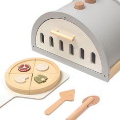 a wooden toy set with a pizza oven and other items to make it look like an oven