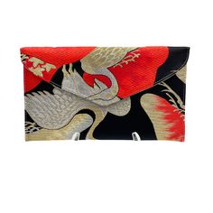 "Unlock timeless style with our meticulously handcrafted evening clutch, a stunning transformation from vintage Kimono Obi. This unique piece is not just a bag; it's a story of strength, longevity, and happiness woven into its very fabric. PATTERN: Embrace the enduring symbolism of the Pine Tree, a resilient plant believed to live for a century. The varied depictions, from angular to mushroom-shaped, tell the tale of age and blossoming. Coupled with the crane motif, a universal symbol of happine Elegant Red Clutch Wallet, Elegant Red Evening Pouch, Elegant Red Evening Wallet, Traditional Handmade Pouch For Formal Occasions, Elegant Rectangular Ceremonial Bag, Elegant Envelope Clutch As Gift, Elegant Rectangular Ceremonial Bags, Elegant Ceremonial Rectangular Bags, Traditional Formal Pouch Clutch